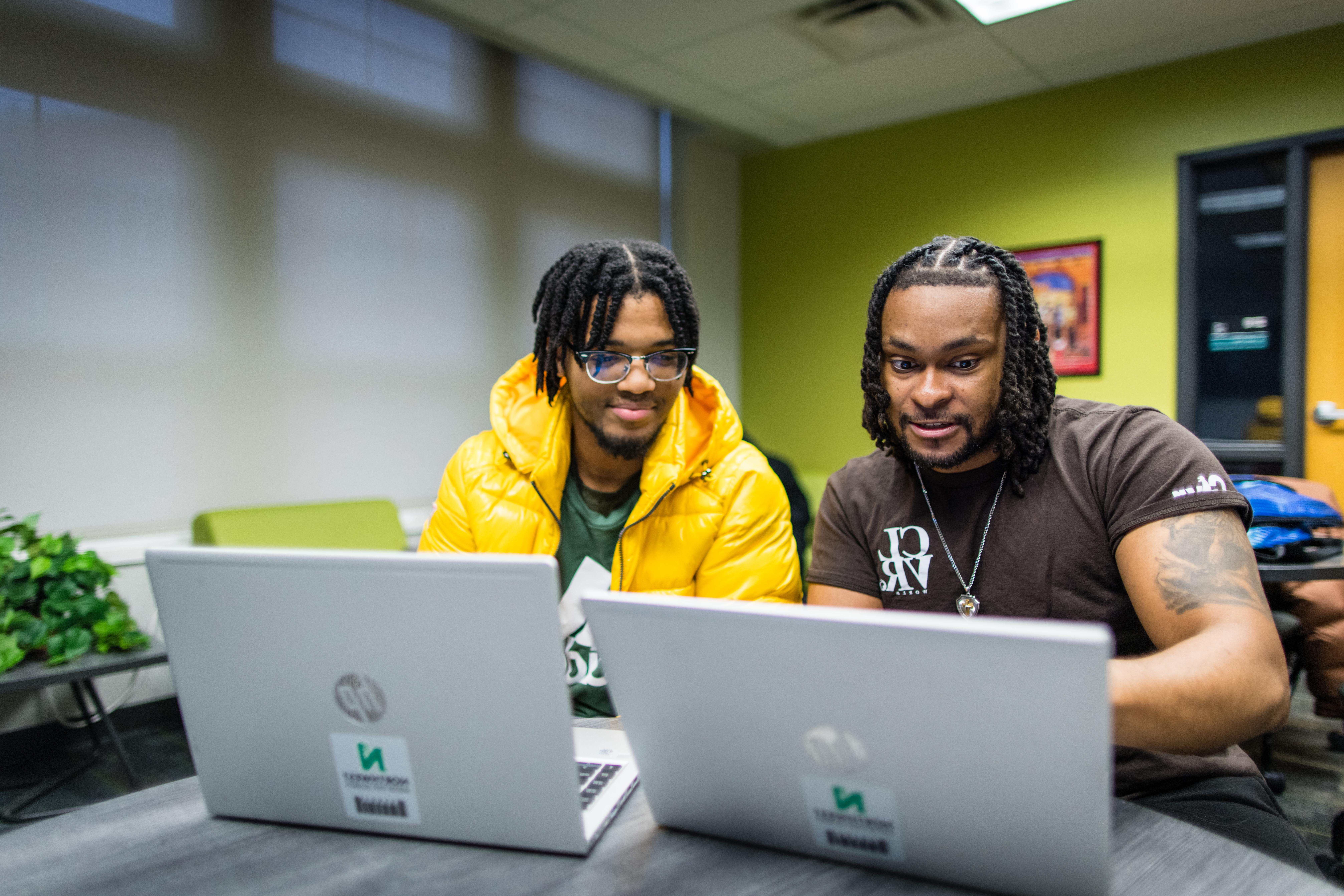 A pair of students use their Northwest laptops to collaborate inside the Office of Diversity and Inclusion.